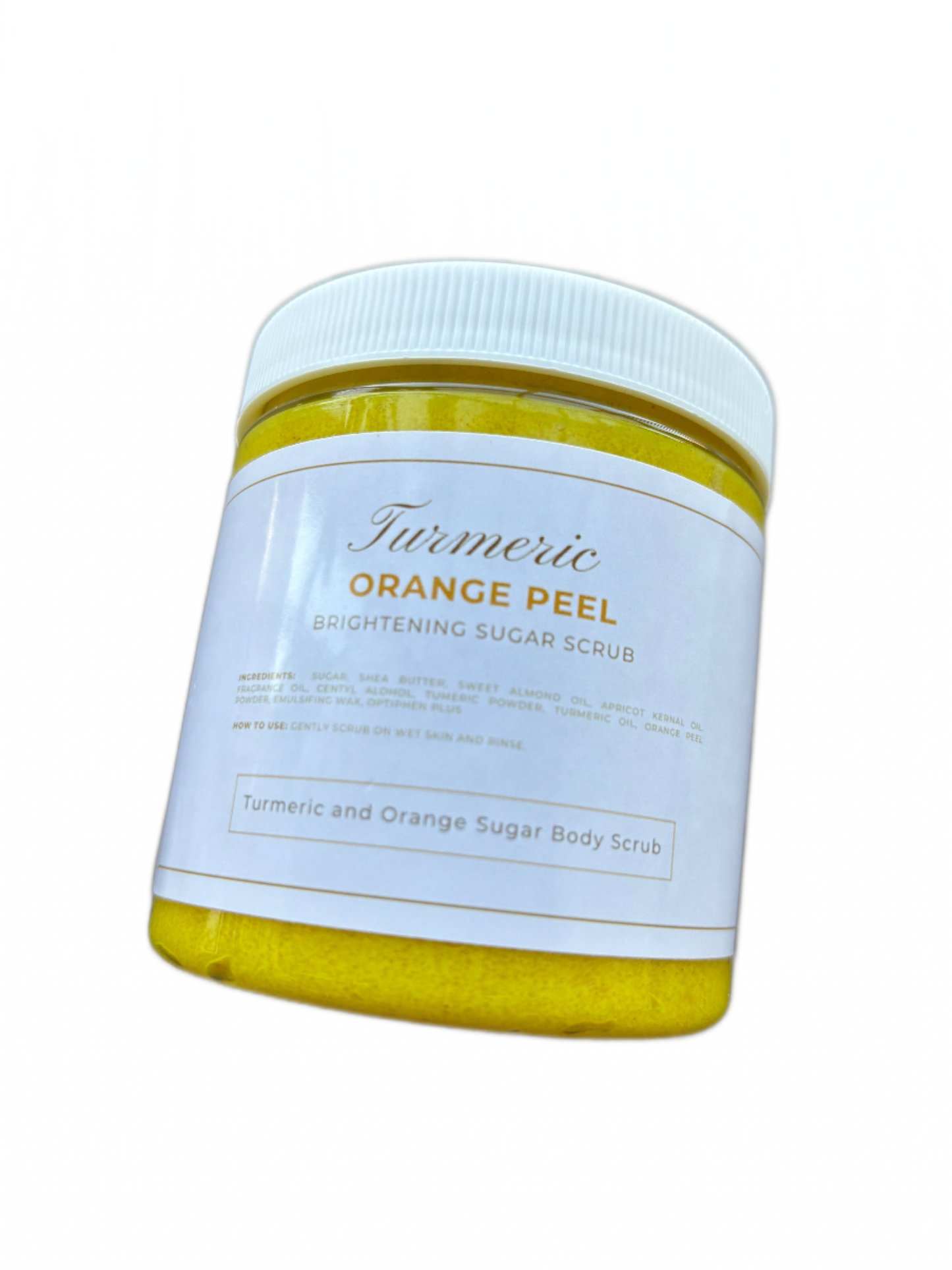 A close up photo our turmeric and orange peel body scrub. The photo is of a 8oz jar of the product. 